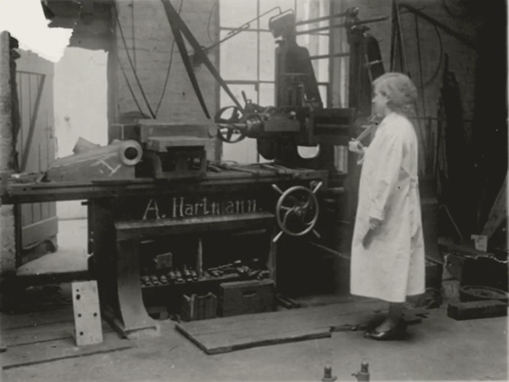 Historic photograph of a machinist at a workbench in an early FUKA workshop