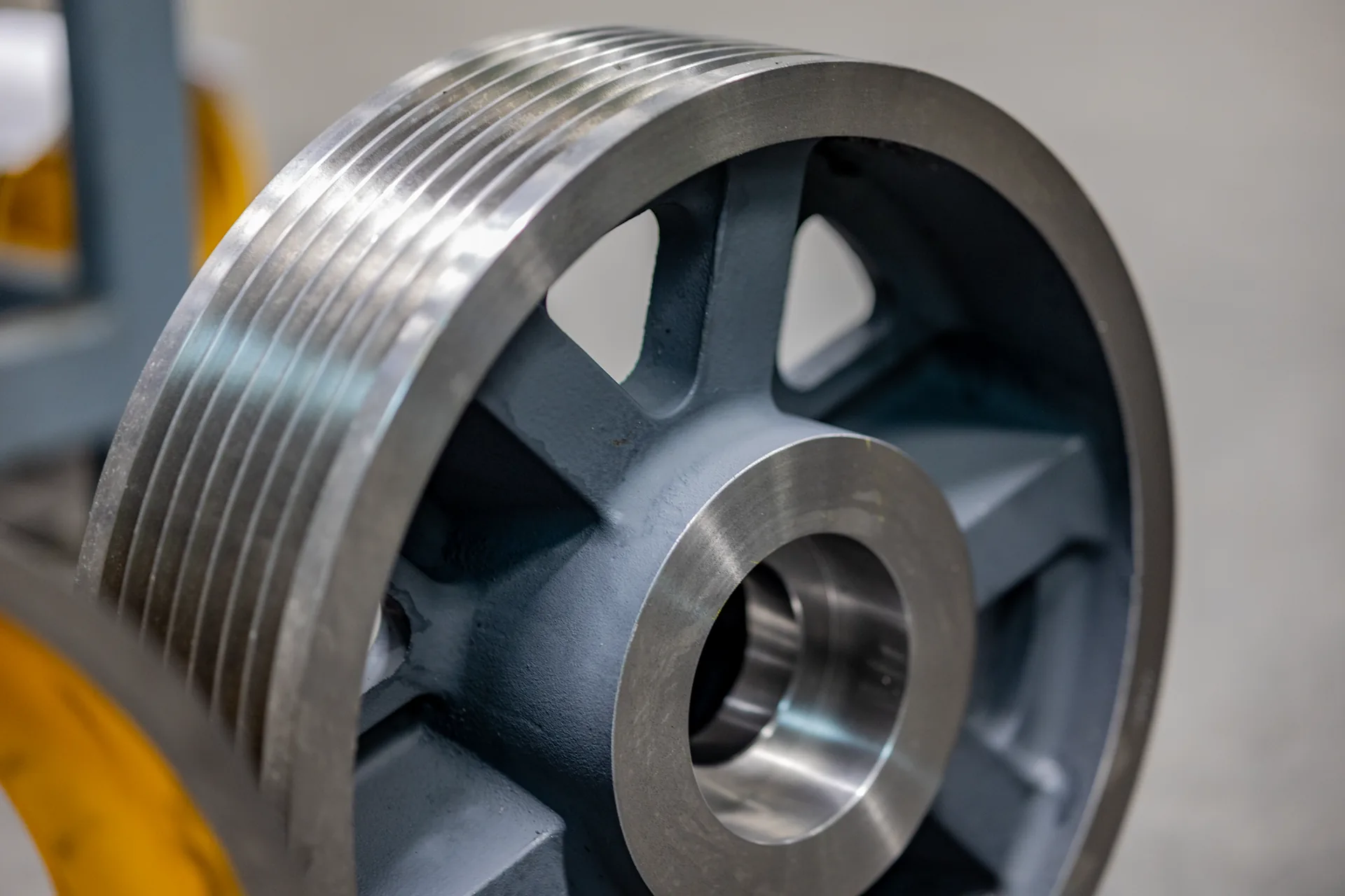 Machined FUKA replacement sheave with finished rope grooves and bearing bore, photographed in the workshop